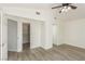 Bright bedroom featuring a ceiling fan, wood flooring, and an entrance to a walk-in closet at 5221 Crooked River Cir, Las Vegas, NV 89149