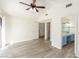 Bright bedroom featuring a ceiling fan, and an ensuite bathroom with a blue vanity and lots of space at 5221 Crooked River Cir, Las Vegas, NV 89149