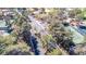 View of the community entry gate flanked by mature trees and tennis courts at 5221 Crooked River Cir, Las Vegas, NV 89149