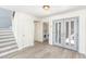 Bright entryway featuring updated flooring, staircase and laundry room with white washer and dryer at 5221 Crooked River Cir, Las Vegas, NV 89149