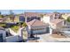 Two-story home with a well-manicured lawn, a two car garage and beautiful landscaping at 5221 Crooked River Cir, Las Vegas, NV 89149