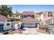 Charming home featuring desert landscaping, a two-car garage, and a decorative gated entrance at 5221 Crooked River Cir, Las Vegas, NV 89149