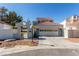 A lovely home with a two car garage, tile roof, and gated entry to the property at 5221 Crooked River Cir, Las Vegas, NV 89149
