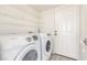 Bright laundry room with Samsung washer and dryer and wire shelves for storage at 5221 Crooked River Cir, Las Vegas, NV 89149
