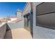 Private upper patio with sliding glass doors and exterior privacy screen at 5221 Crooked River Cir, Las Vegas, NV 89149