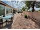 Charming backyard with patio dining, low-maintenance landscaping and block wall providing privacy at 5422 Nestled Moon Ct, Las Vegas, NV 89131
