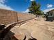 Spacious backyard with a brick wall, stone walkway, and potential for landscaping at 5422 Nestled Moon Ct, Las Vegas, NV 89131