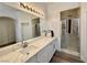 Bathroom features a double vanity with granite counters, a spacious walk-in shower, and modern fixtures at 5422 Nestled Moon Ct, Las Vegas, NV 89131