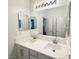 Bright bathroom featuring double sinks, quartz countertops and a large mirror at 5422 Nestled Moon Ct, Las Vegas, NV 89131