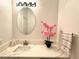 Bright bathroom featuring a modern vanity with white countertop and decorative pink flowers at 5422 Nestled Moon Ct, Las Vegas, NV 89131