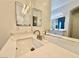 Bathroom vanity featuring marble countertops, modern faucet fixtures, and ample lighting at 5422 Nestled Moon Ct, Las Vegas, NV 89131