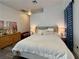 Inviting bedroom with a cozy queen-size bed, decorative lighting, and a view of the outdoors at 5422 Nestled Moon Ct, Las Vegas, NV 89131