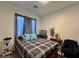 Cozy bedroom features plaid bedding, blue accents, and plenty of natural light at 5422 Nestled Moon Ct, Las Vegas, NV 89131