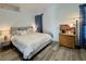 Comfortable bedroom with plush bedding, hardwood floors, and decorative pillows for a relaxing retreat at 5422 Nestled Moon Ct, Las Vegas, NV 89131