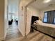 A bedroom featuring a bed in the foreground, with other rooms visible through open doors at 5422 Nestled Moon Ct, Las Vegas, NV 89131