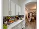 A clean butlers pantry area that features white cabinets, marble countertops, and decorative accents at 5422 Nestled Moon Ct, Las Vegas, NV 89131