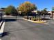 Community entrance gate with wrought iron details, lush trees, and a neighborhood street at 5422 Nestled Moon Ct, Las Vegas, NV 89131