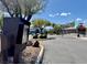 Gated community entrance featuring a secure access point, lush landscaping, and well-maintained street at 5422 Nestled Moon Ct, Las Vegas, NV 89131