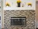 Modern fireplace with unique tile surround and decorative mantle, perfect for cozy evenings at 5422 Nestled Moon Ct, Las Vegas, NV 89131