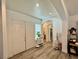 Spacious foyer with wood-look flooring, arched doorway, and modern decor at 5422 Nestled Moon Ct, Las Vegas, NV 89131
