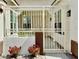 Inviting front porch with decorative gate, potted plants, and a welcoming entrance at 5422 Nestled Moon Ct, Las Vegas, NV 89131