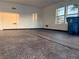 Clean garage with epoxy flooring, natural light, and a blue trash container at 5422 Nestled Moon Ct, Las Vegas, NV 89131