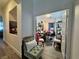 Cozy hallway with a cushioned chair leading to a bright, organized office space at 5422 Nestled Moon Ct, Las Vegas, NV 89131