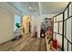 Bright hallway featuring new laminate flooring and neutral wall paint with an open archway at 5422 Nestled Moon Ct, Las Vegas, NV 89131