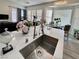 Bright kitchen with a stainless steel sink and faucet, marble countertops, and many windows at 5422 Nestled Moon Ct, Las Vegas, NV 89131