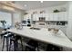 Bright kitchen features white cabinets, stainless appliances, and a large island with seating at 5422 Nestled Moon Ct, Las Vegas, NV 89131