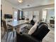 Open-concept living area with mirrored dining table, comfortable seating, and outdoor access at 5422 Nestled Moon Ct, Las Vegas, NV 89131