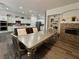 The open concept living and dining area featuring a modern kitchen and fireplace at 5422 Nestled Moon Ct, Las Vegas, NV 89131