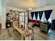 Bright living room has wood floors, a decorative chandelier, and large comfortable sofa at 5422 Nestled Moon Ct, Las Vegas, NV 89131