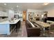 Open-concept living and kitchen area with modern decor, long island, and comfortable seating at 5422 Nestled Moon Ct, Las Vegas, NV 89131
