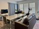 Open living room featuring exercise equipment, dining table, and comfortable seating at 5422 Nestled Moon Ct, Las Vegas, NV 89131