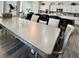 Open-concept kitchen and dining space with a mirrored table and seating, perfect for entertaining at 5422 Nestled Moon Ct, Las Vegas, NV 89131