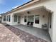 Rear patio with tile flooring, ceiling fan, and comfortable seating area at 5422 Nestled Moon Ct, Las Vegas, NV 89131