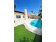 Inviting backyard with a refreshing pool, manicured lawn, and privacy landscaping at 5521 Desert Valley Dr, Las Vegas, NV 89149