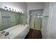 Bathroom with double sinks, a walk-in shower, and modern fixtures create a spa-like feel at 5521 Desert Valley Dr, Las Vegas, NV 89149
