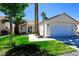 Charming single-story home featuring a well-maintained lawn and attached two-car garage at 5521 Desert Valley Dr, Las Vegas, NV 89149
