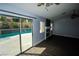 Living room overlooking a pool with sliding glass doors, fireplace and ceiling fan at 5521 Desert Valley Dr, Las Vegas, NV 89149