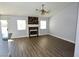 Open-concept living area with a decorative fireplace, ceiling fan and wood-look floors at 5521 Desert Valley Dr, Las Vegas, NV 89149