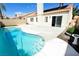 Sparkling pool with easy access to the house, adjacent to a patio and lush plantings at 5521 Desert Valley Dr, Las Vegas, NV 89149