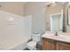 Bathroom features a tub, toilet, sink, and a large mirror with a wood frame at 5915 Nuevo Leon St # 8, North Las Vegas, NV 89031