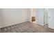This bedroom has neutral walls, carpet flooring, and an open door leading to a bathroom at 5915 Nuevo Leon St # 8, North Las Vegas, NV 89031