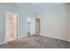 Spacious bedroom with carpet flooring, with a view of the bathroom and walk-in closet at 5915 Nuevo Leon St # 8, North Las Vegas, NV 89031