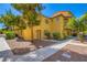 Beautiful multi-level townhouse with balcony and landscaped grounds, creating an inviting curb appeal at 5915 Nuevo Leon St # 8, North Las Vegas, NV 89031