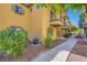 Charming townhouse featuring a balcony, shuttered windows and landscaped grounds, creating an inviting curb appeal at 5915 Nuevo Leon St # 8, North Las Vegas, NV 89031
