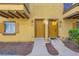 Inviting townhouse exterior featuring a cozy balcony, a well-maintained landscape, and a welcoming pathway at 5915 Nuevo Leon St # 8, North Las Vegas, NV 89031
