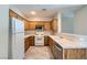 Bright kitchen featuring wooden cabinets and stainless steel appliances, enhancing functionality at 5915 Nuevo Leon St # 8, North Las Vegas, NV 89031